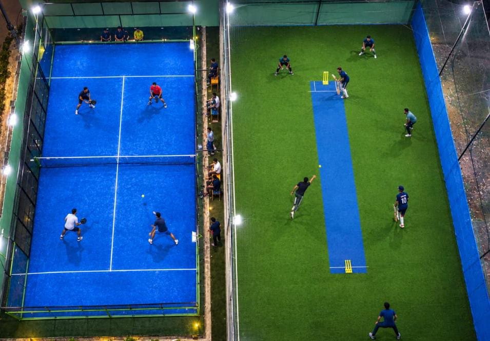 A floodlit night at Zone 36, a cricket match on the turf and a padel doubles game on the court beside it