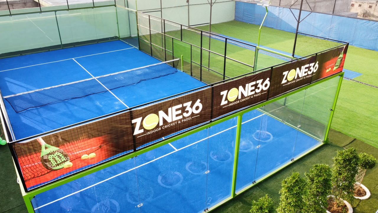 The glass padel court at Zone 36 with branded surrounds